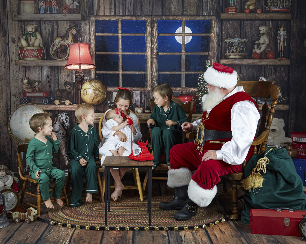 Santa with 5 children and baby on North Pole phone
